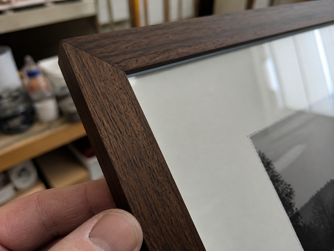 Close-up of museum glass and archival custom framing at Masten