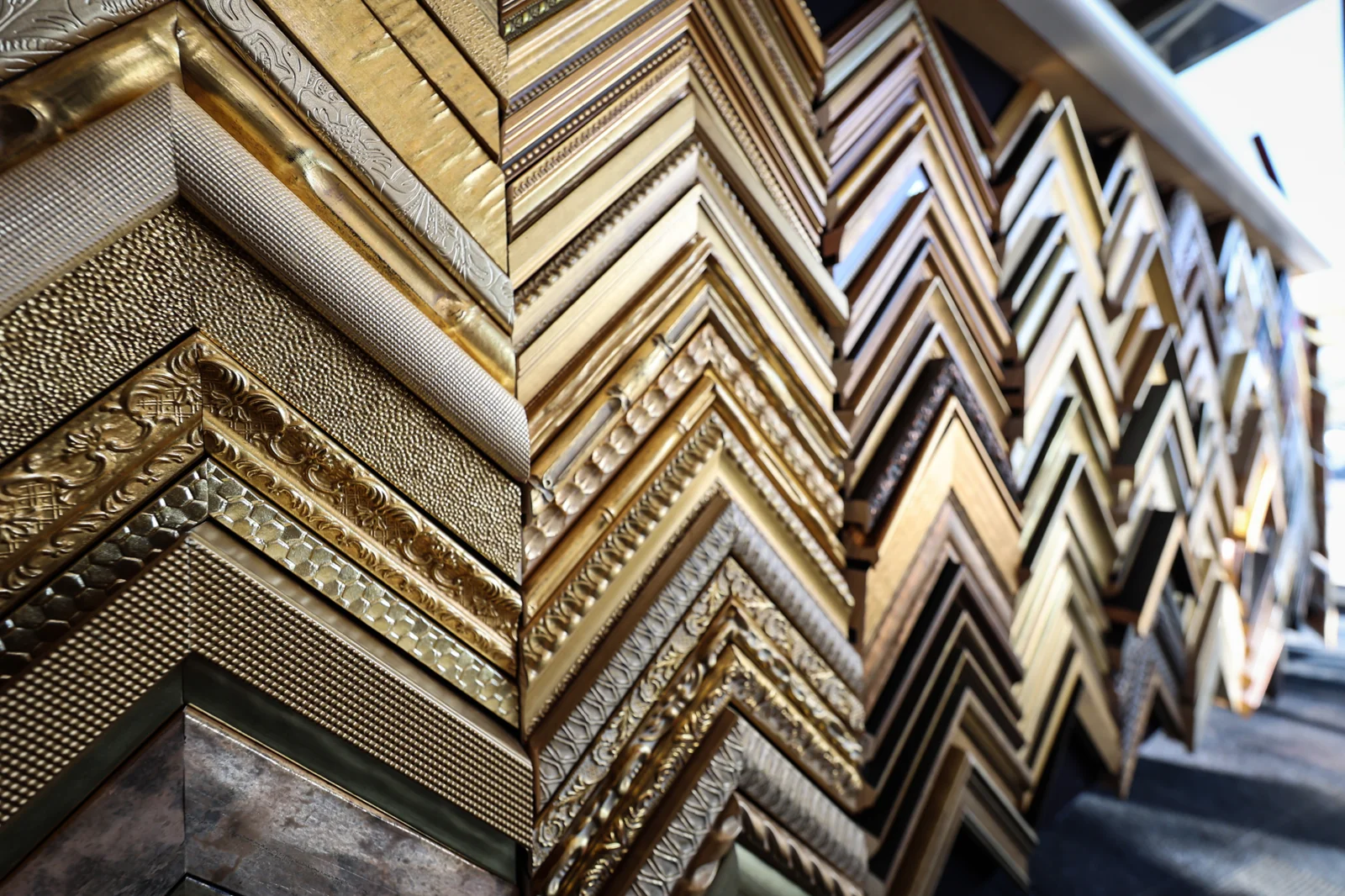Luxury framing consultation studio with curated frame moulding samples and design materials